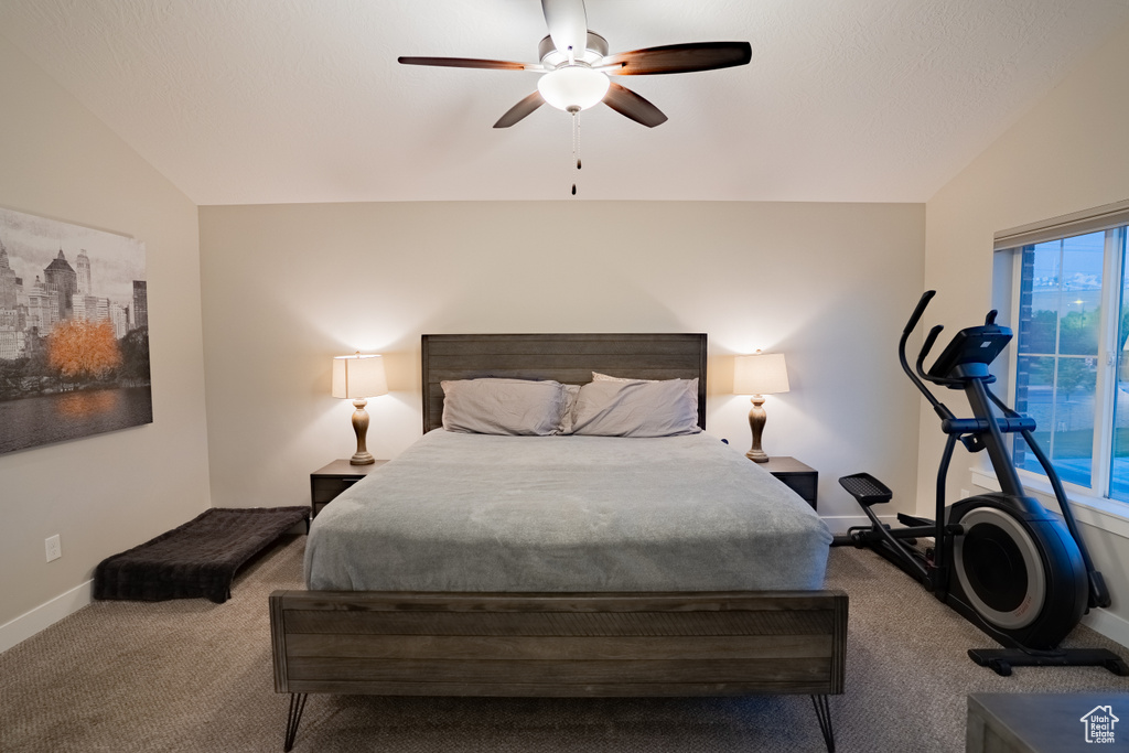 Bedroom featuring carpet, vaulted ceiling, baseboards, and ceiling fan