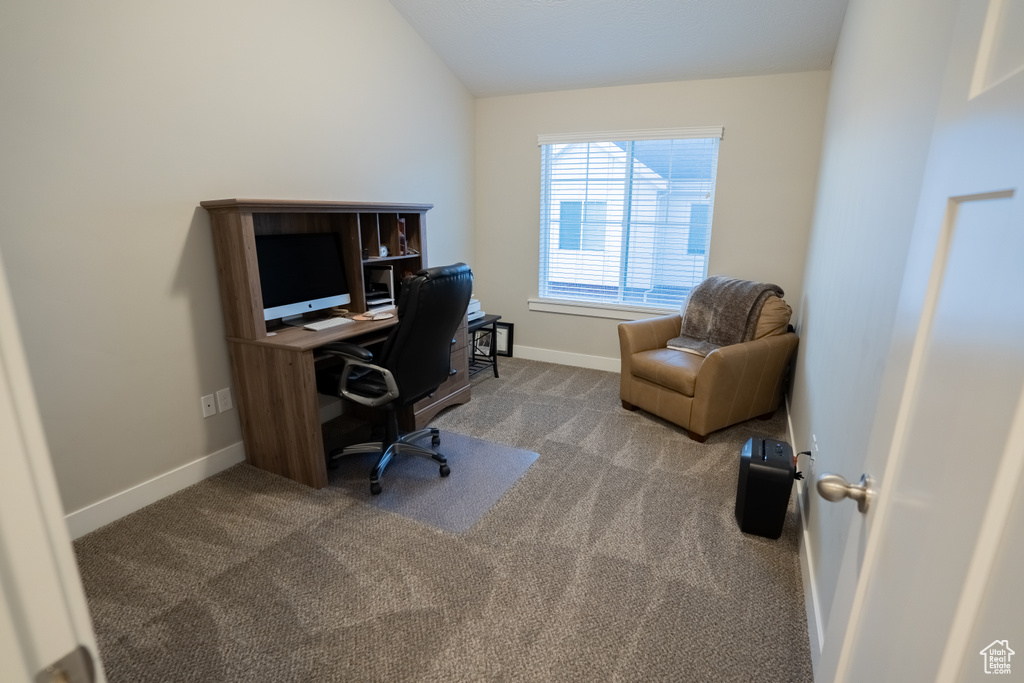 Home office featuring carpet flooring, baseboards, and lofted ceiling