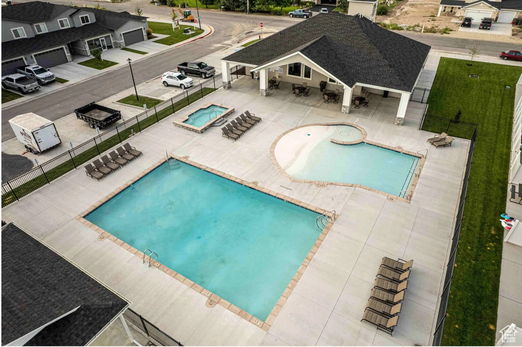 Community pool featuring a patio and a community hot tub