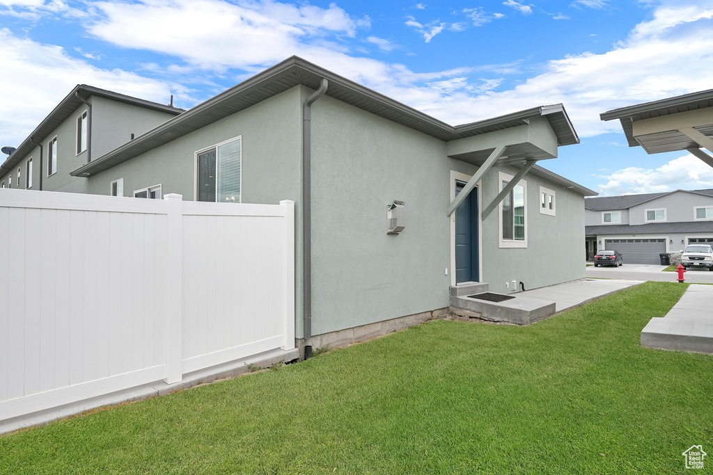 Rear view of house featuring stucco siding