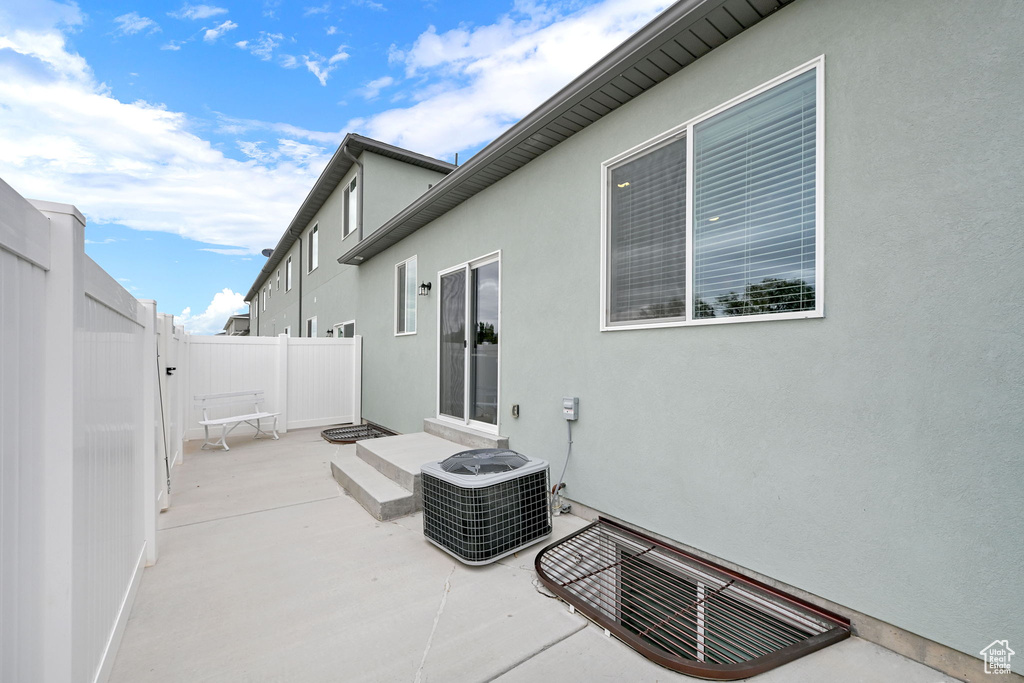 Fenced backyard featuring a patio area and central AC