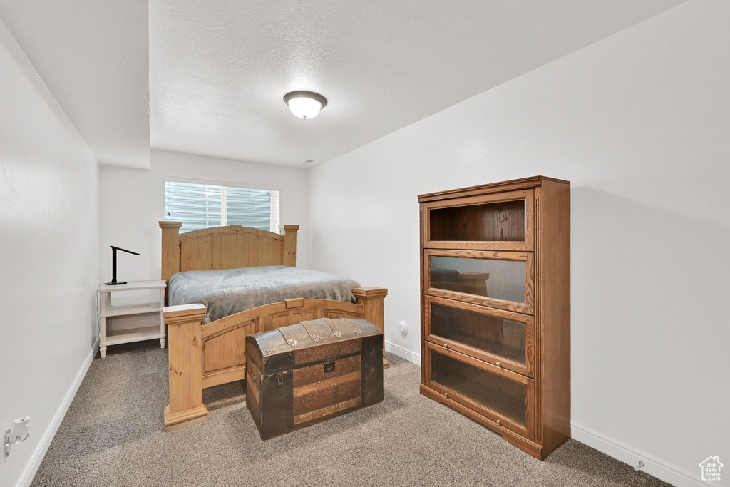 Carpeted bedroom featuring baseboards