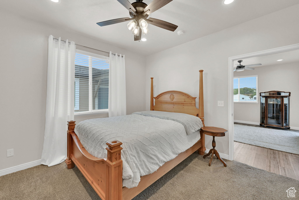 Carpeted bedroom featuring recessed lighting, baseboards, and a ceiling fan
