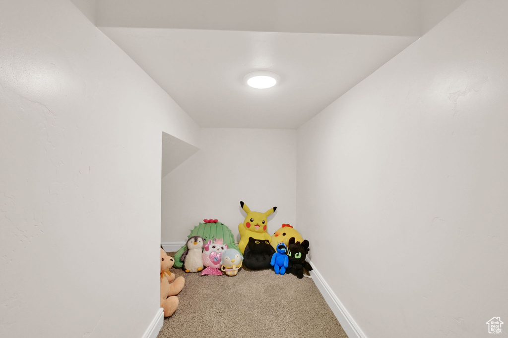 Recreation room with carpet flooring and baseboards