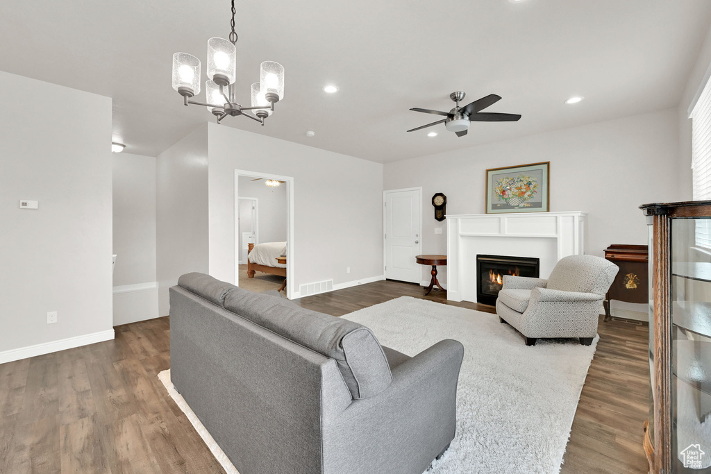 Living area with a ceiling fan, dark wood-type flooring, baseboards, and recessed lighting