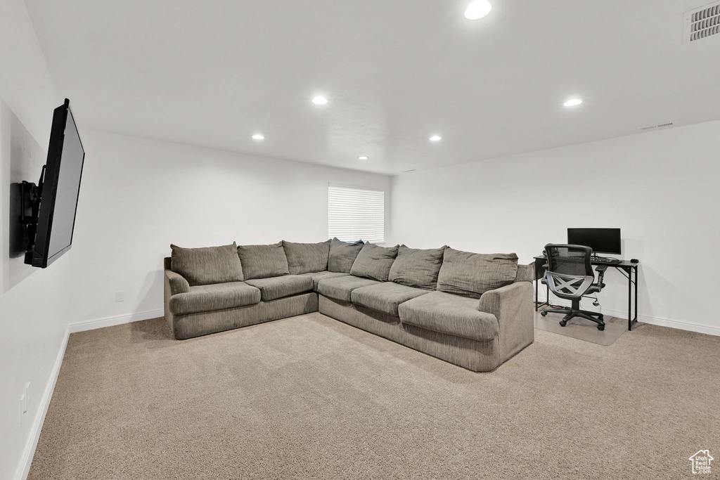 Living room with recessed lighting, light carpet, and baseboards
