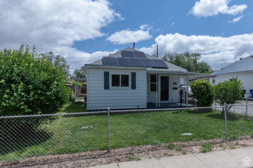 Bungalow-style home featuring roof mounted solar panels and roof with shingles