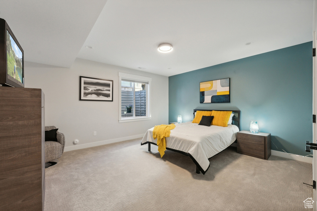 Bedroom featuring carpet flooring and baseboards