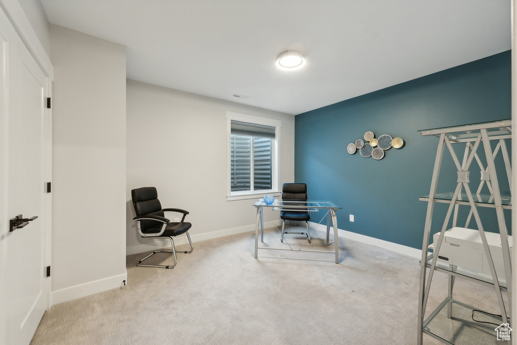 Carpeted office space featuring baseboards