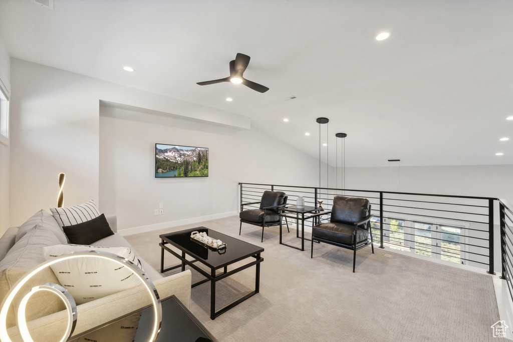 Living room with ceiling fan, recessed lighting, lofted ceiling, light carpet, and baseboards