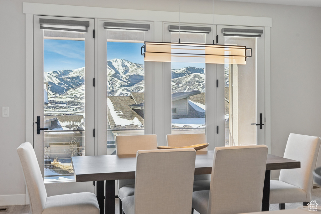 Dining space with a mountain view and wood finished floors
