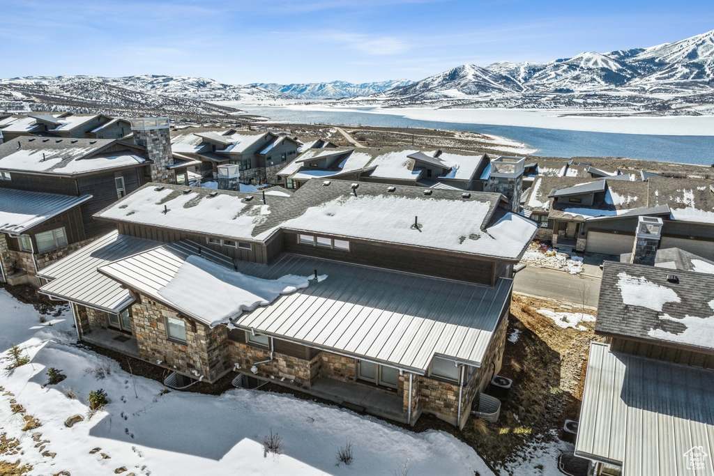 Snowy aerial view with a mountain view and a residential view