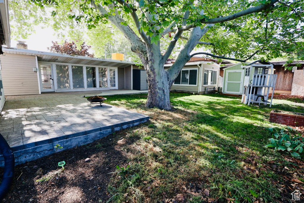 Back of property with a patio area and a yard
