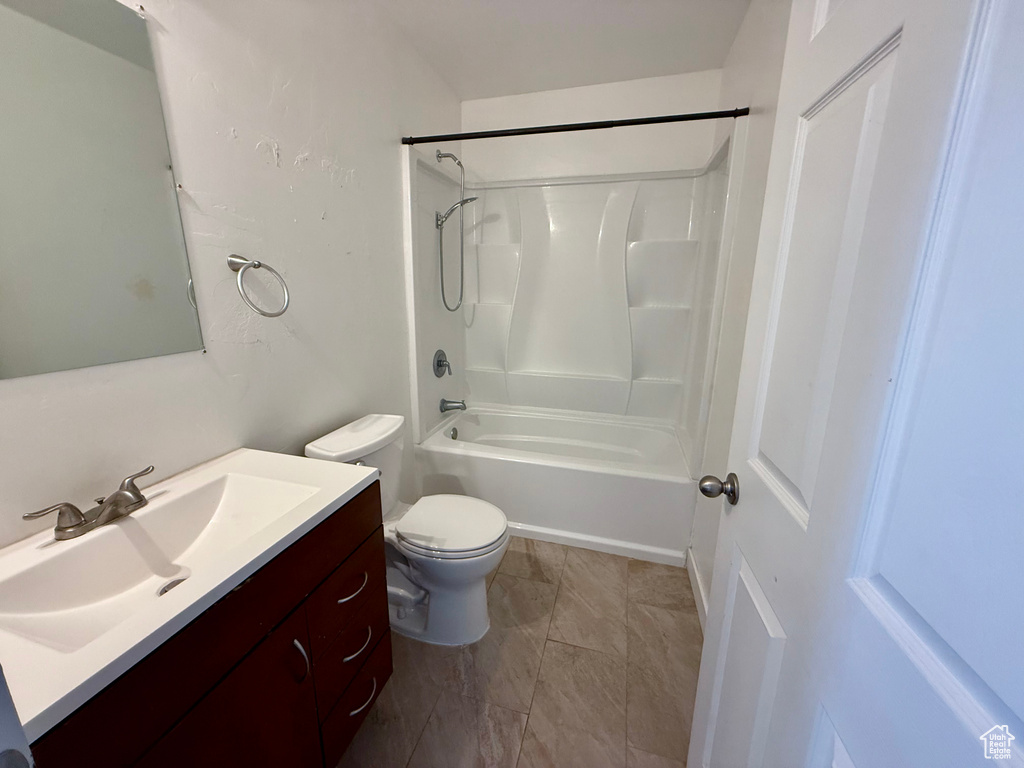 Full bathroom with toilet, vanity, and  shower combination