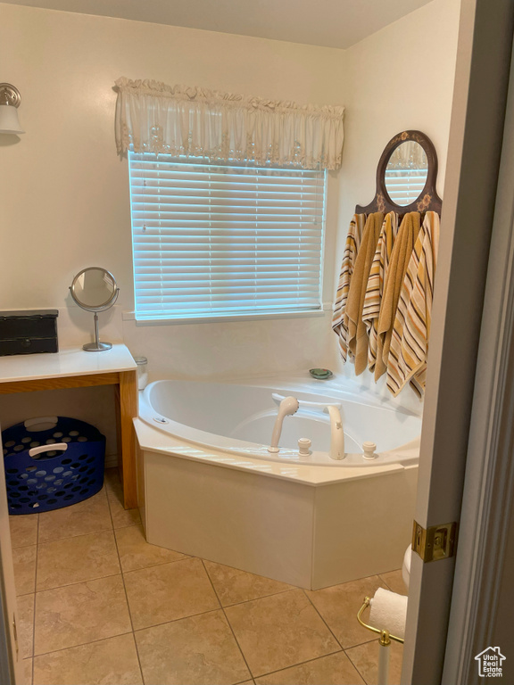 Full bathroom with tile patterned floors and a bath