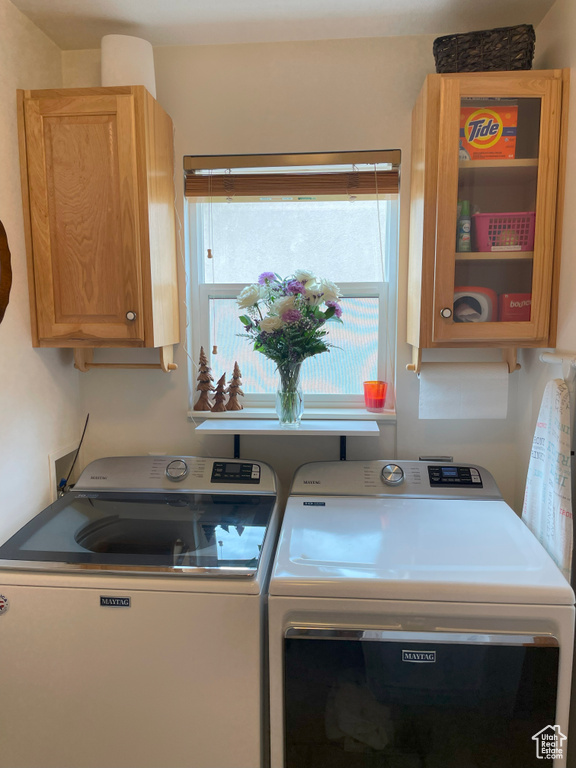 Laundry room featuring washing machine and dryer and cabinet space
