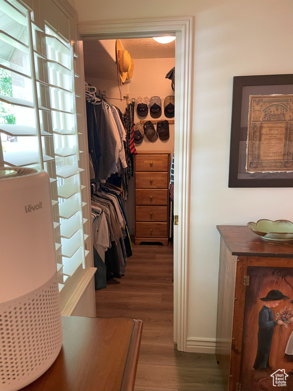 Walk in closet featuring wood finished floors