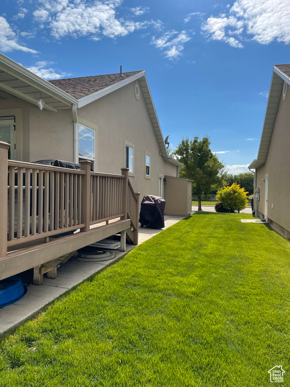 View of green lawn with a deck