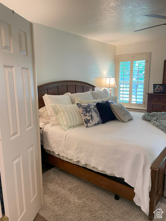 Bedroom with carpet and a textured ceiling