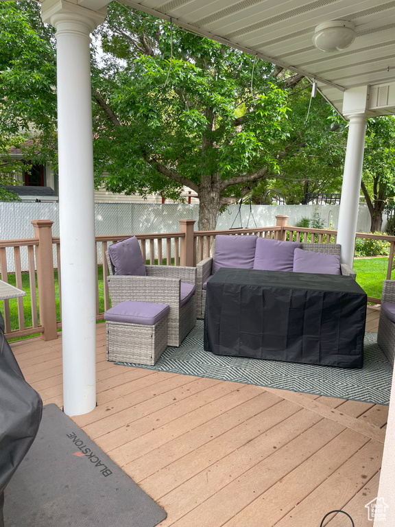 Wooden deck with outdoor lounge area and a fenced backyard