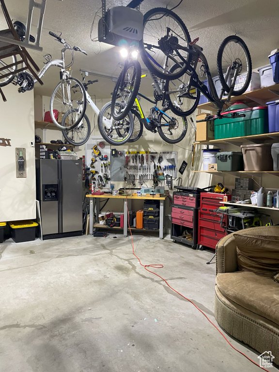 Garage with a workshop area and a garage door opener