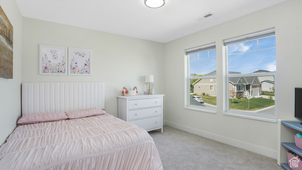 Bedroom with light carpet and baseboards