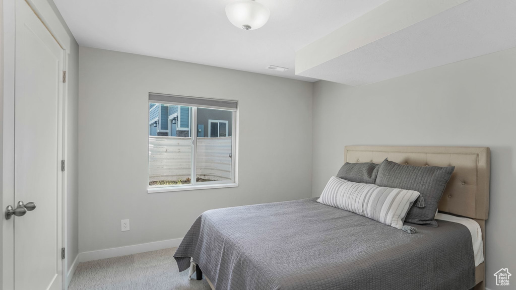 Bedroom featuring carpet flooring and baseboards