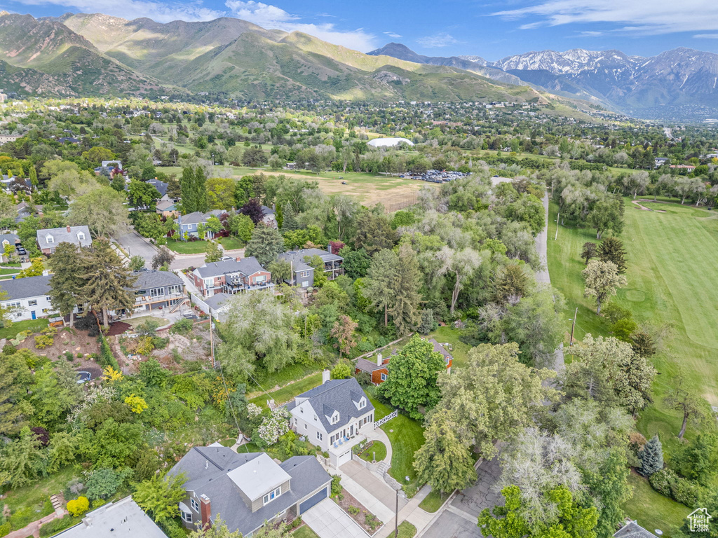 Aerial view of property's location featuring mountains and nearby suburban area