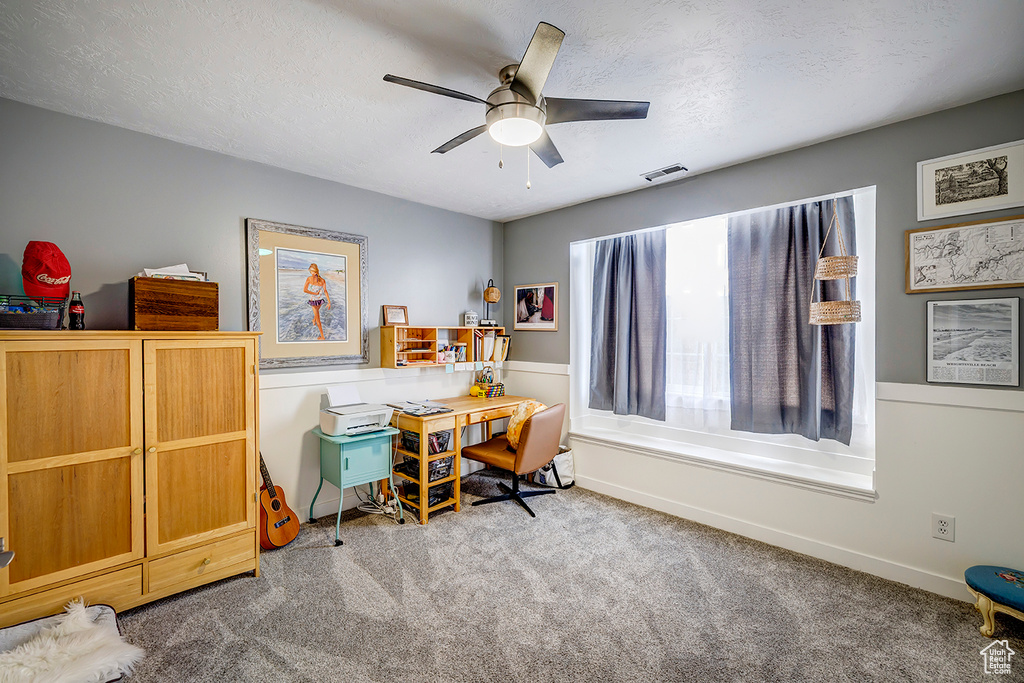 Carpeted office with ceiling fan, a textured ceiling, and baseboards