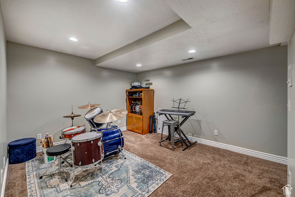 Recreation room with carpet flooring, recessed lighting, baseboards, and a textured ceiling