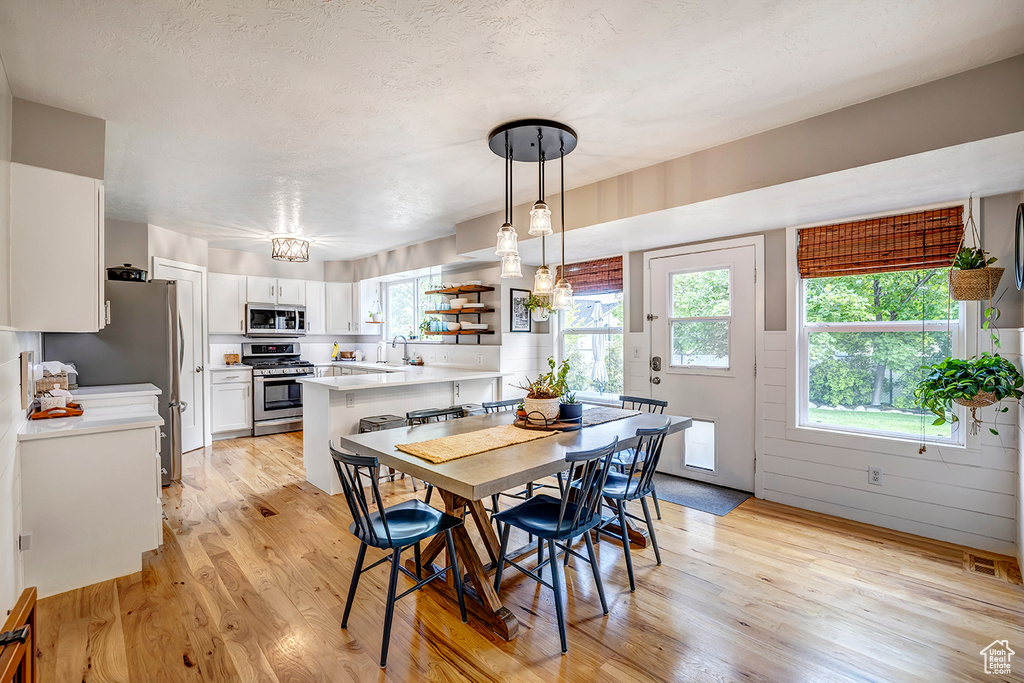 Dining room featuring light wood finished floors and a chandelier