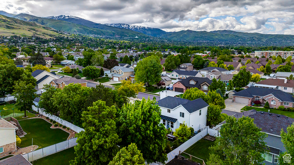 Aerial view of residential area featuring a mountainous background