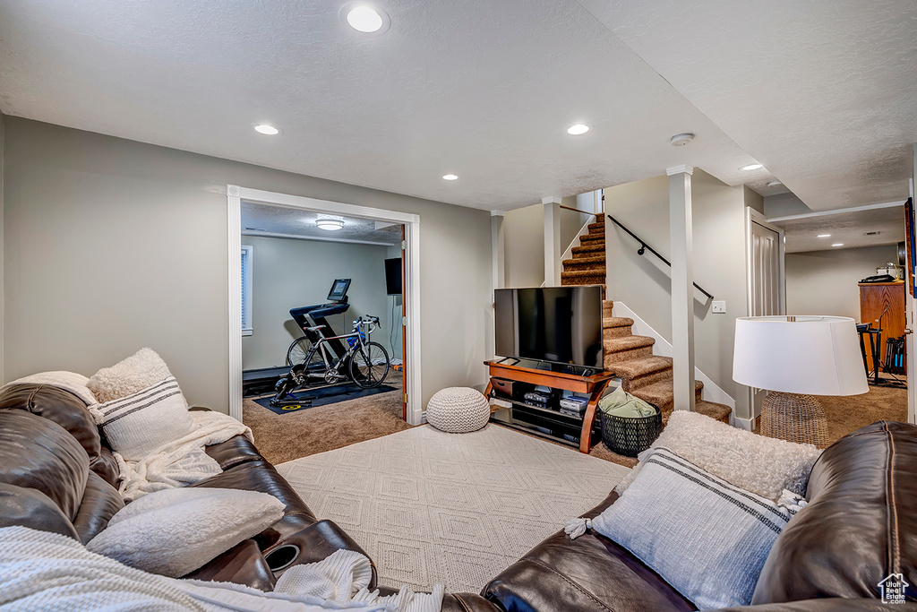 Living room with carpet, recessed lighting, stairway, and baseboards