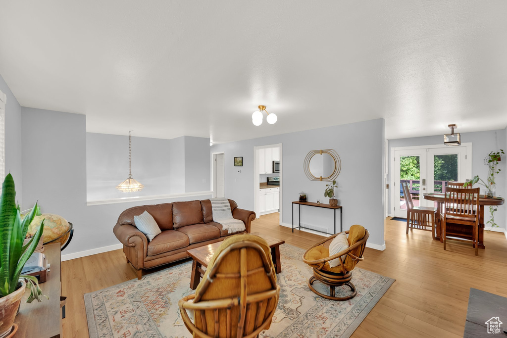 Living area featuring light wood-style floors and baseboards