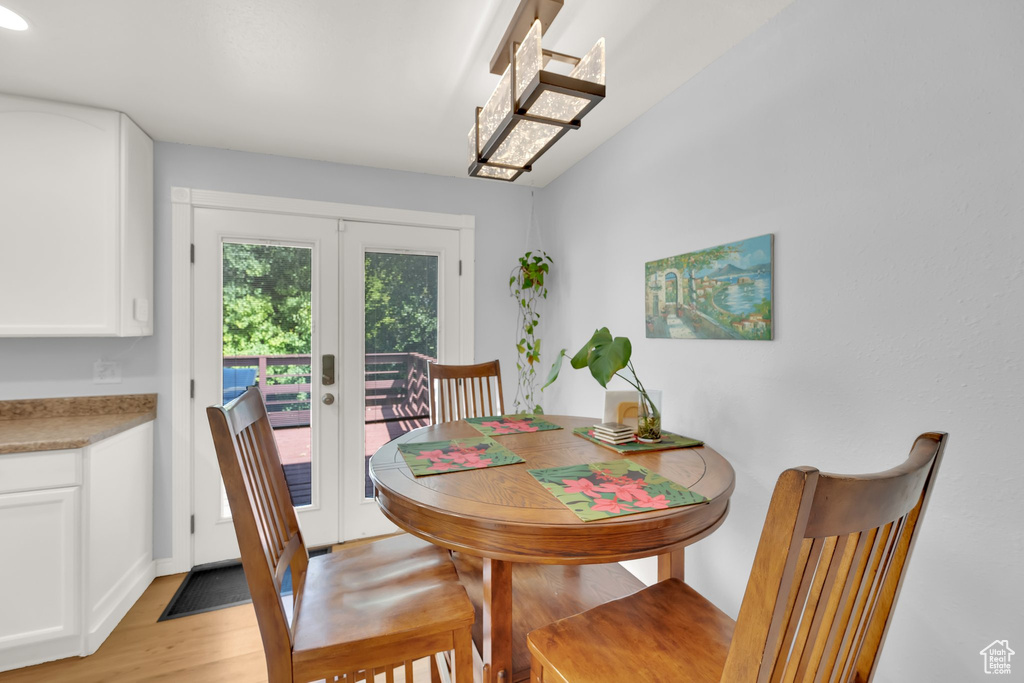 Dining room featuring french doors and light wood-style flooring