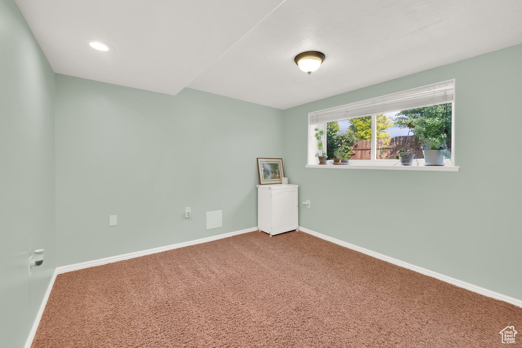 Unfurnished room featuring baseboards and carpet floors