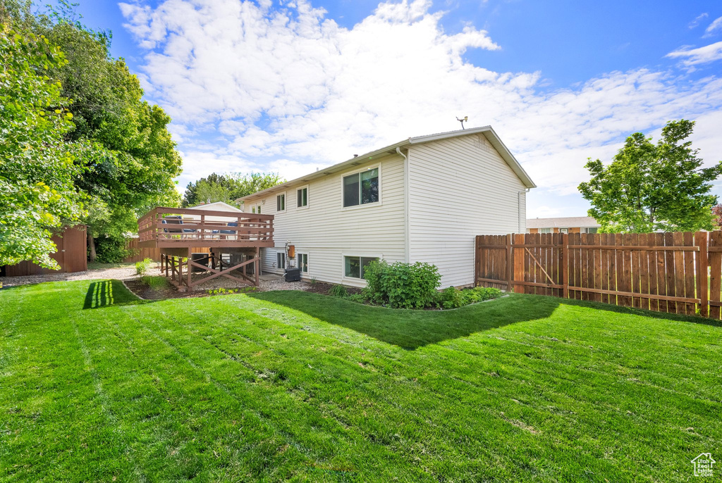 Rear view of property with a wooden deck