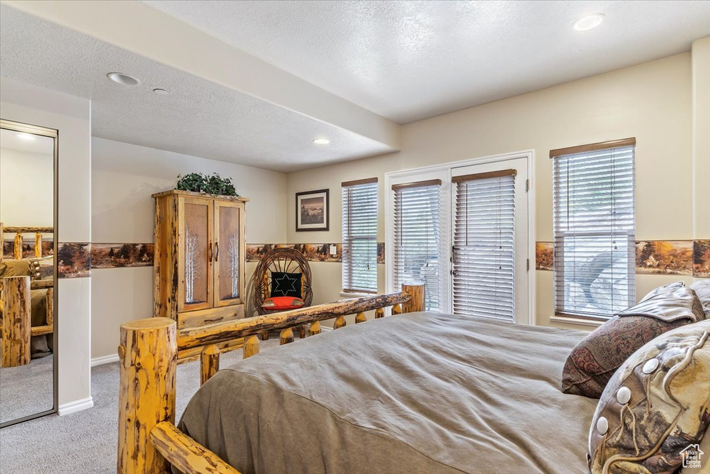 Bedroom featuring carpet floors, multiple windows, recessed lighting, and access to outside