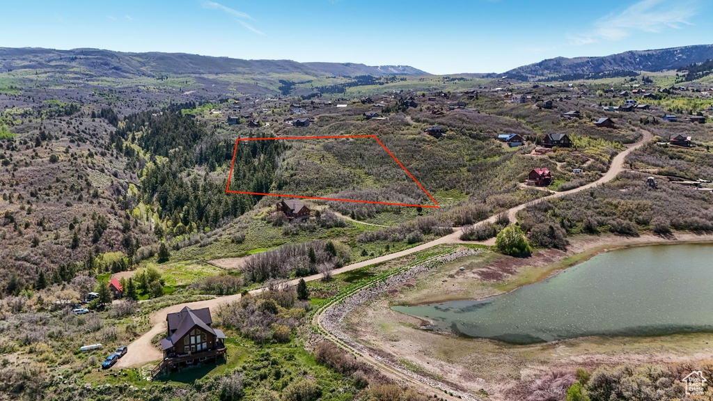 Aerial view of property's location featuring property boundaries highlighted and a water and mountain view