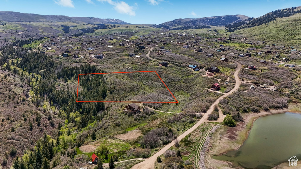 Aerial overview of property's location featuring property parcel outlined and a water and mountain view