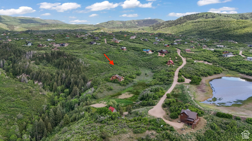 Aerial overview of property's location featuring a water and mountain view