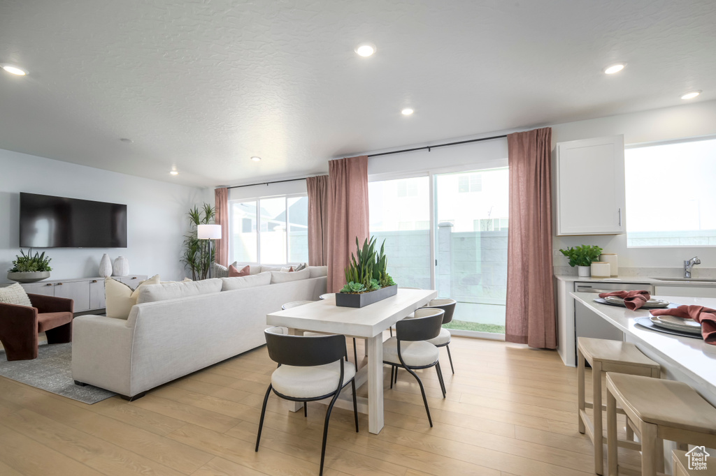 Dining space with light wood-style flooring and recessed lighting