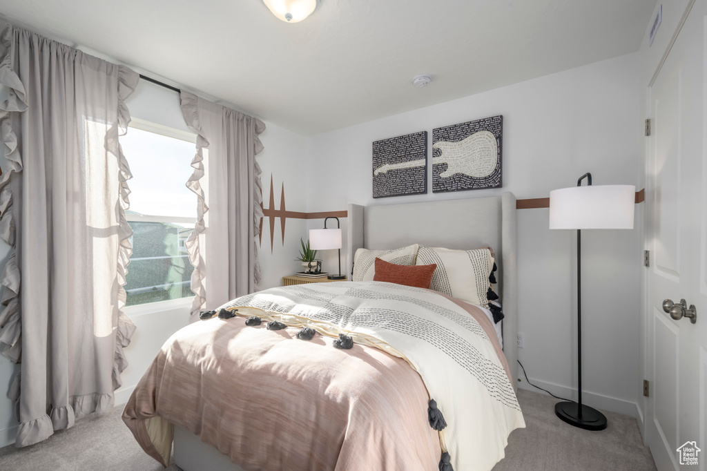 Bedroom featuring light colored carpet