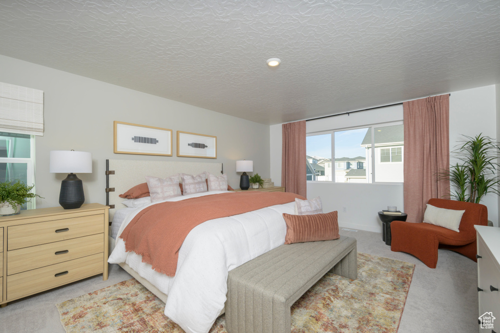 Bedroom featuring light carpet