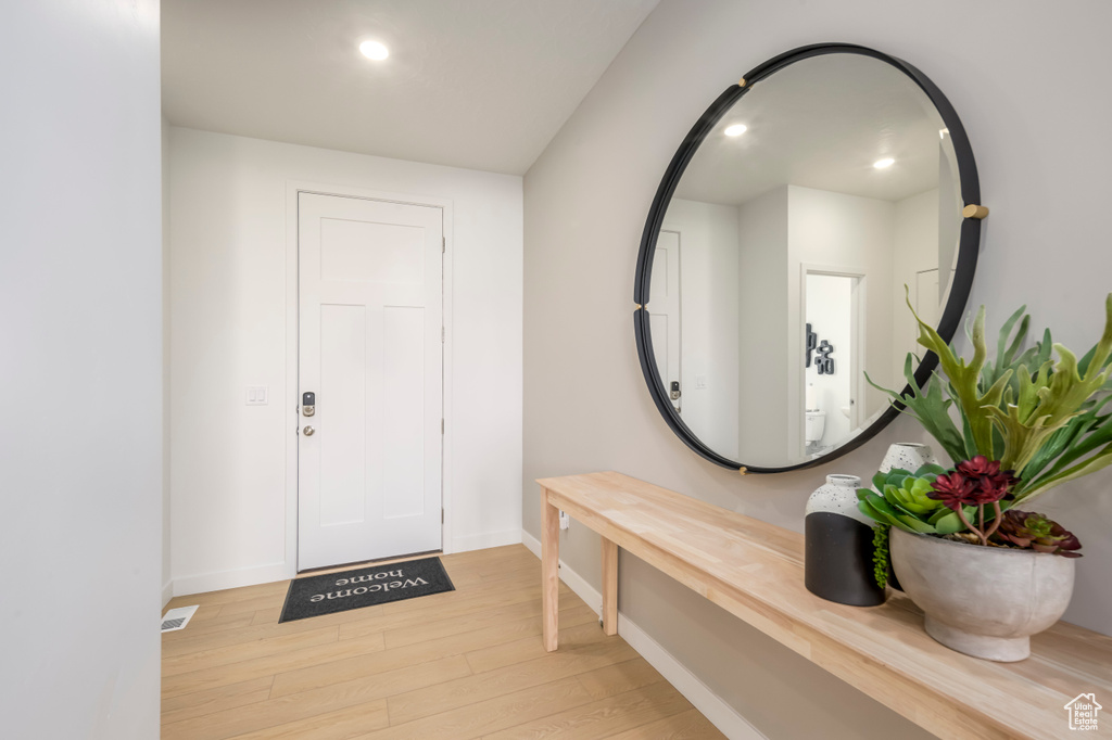 Entryway featuring baseboards, light wood-style floors, and recessed lighting