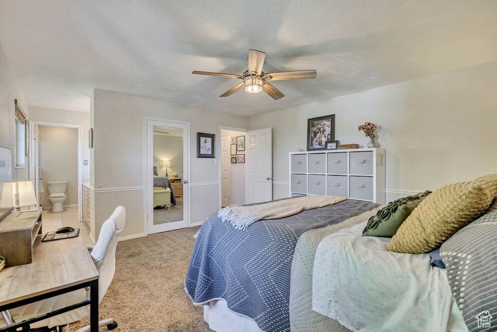 Carpeted bedroom featuring baseboards and a ceiling fan