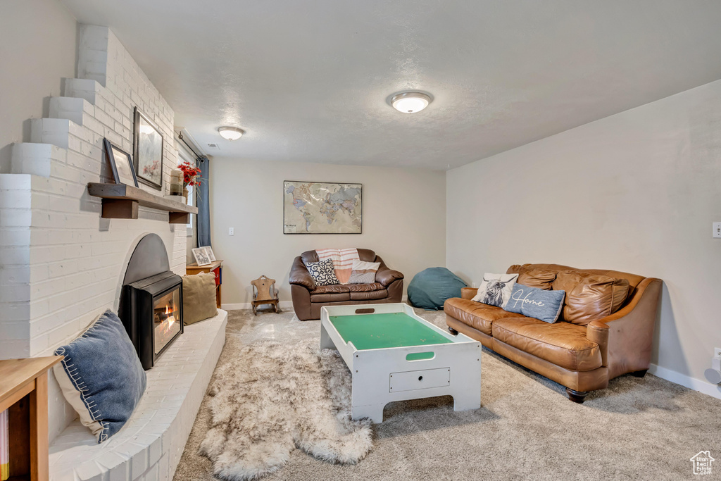 Living area featuring carpet flooring and baseboards