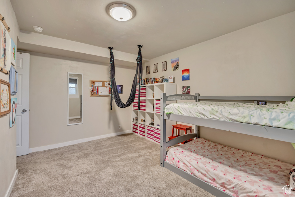 Bedroom with carpet floors and baseboards