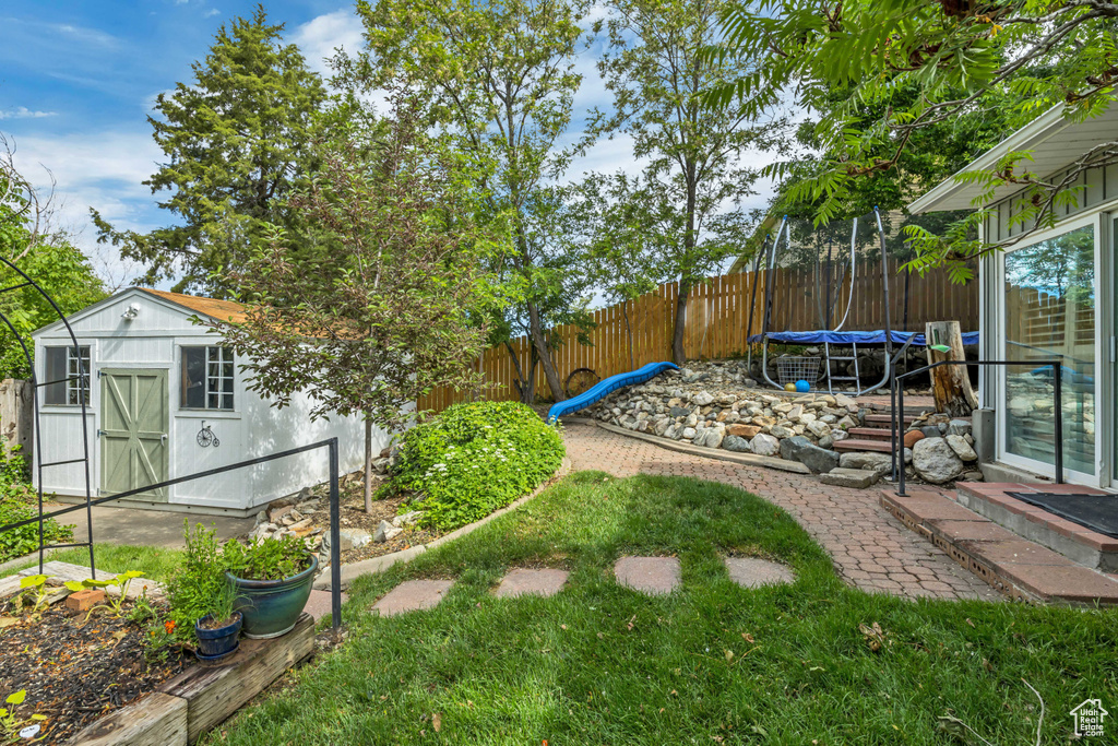 Fenced backyard with a trampoline
