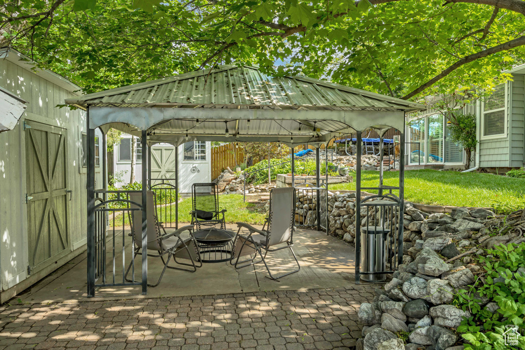 View of patio featuring a gazebo and an outdoor fire pit
